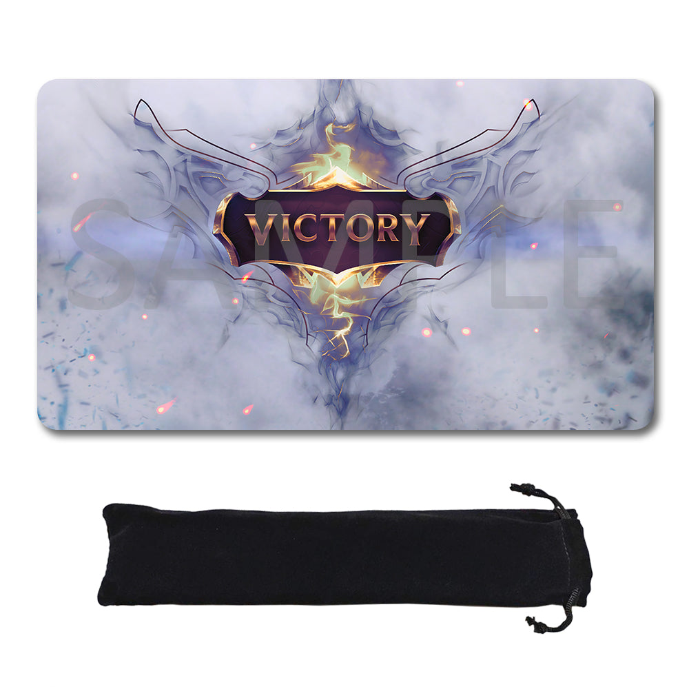A rectangular gaming mouse pad with a fantasy-style design featuring the word 'VICTORY' in a gold shield over smoky blue and white artwork, shown above a black drawstring storage pouch on a white background.
