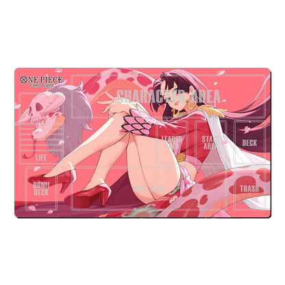 A rectangular anime playmat featuring One Piece: Pirate Square characters, with a pink and red design, an illustration of a character in a red outfit, and printed game area labels such as life, deck, trash, and character area.