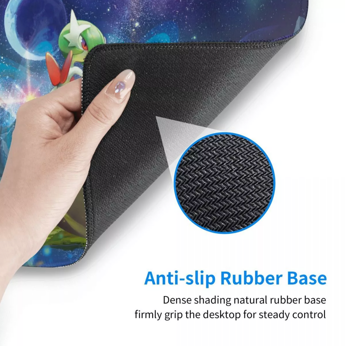 A hand lifts the corner of a colorful printed desk mat to reveal a black anti-slip rubber base, with a circular inset showing the textured rubber surface and text reading 'Anti-slip Rubber Base.'.