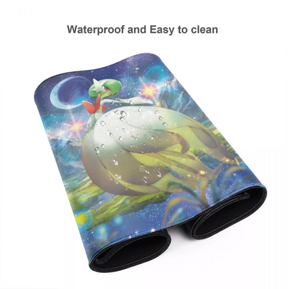 A rolled-up desk mat or mouse pad with a colorful space-themed print featuring a green creature on a planet, water droplets, and stars. The text 'Waterproof and Easy to clean' is displayed above the product on a plain white background.