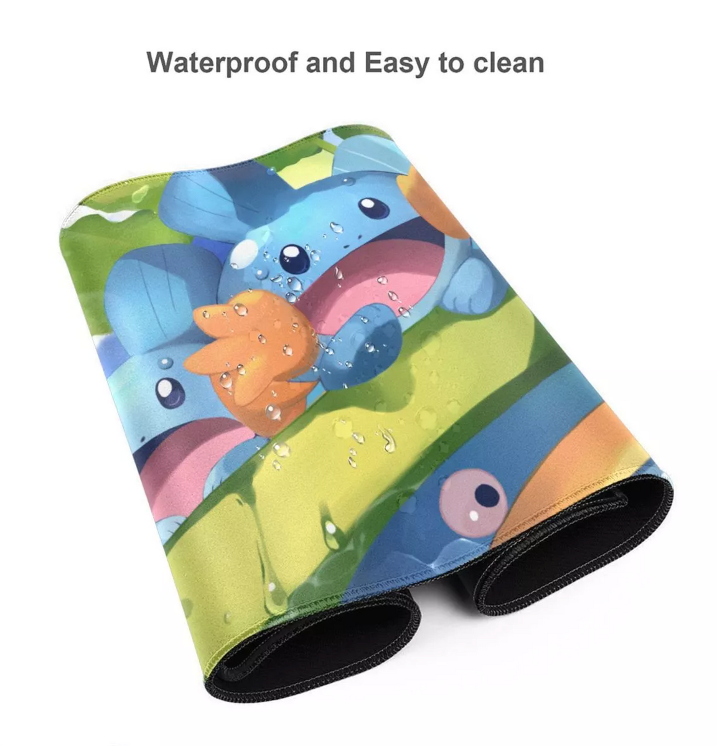 A rectangular mat with a colorful cartoon print of blue characters on a green and yellow background, shown rolled at the bottom. Text at the top reads 'Waterproof and Easy to clean' on a plain white background.