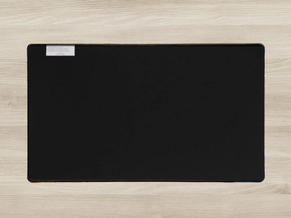 Black desk mat on a light wood surface