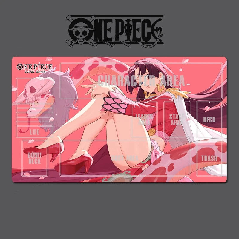 A One Piece themed desk mat or gaming playmat featuring an anime illustration of a character in a pink outfit, with a large One Piece logo printed above the mat on a dark gray background.