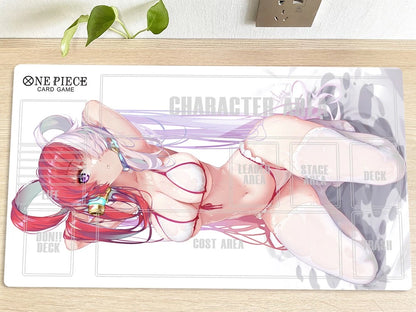 Anime character card on a game mat with 'One Piece' branding