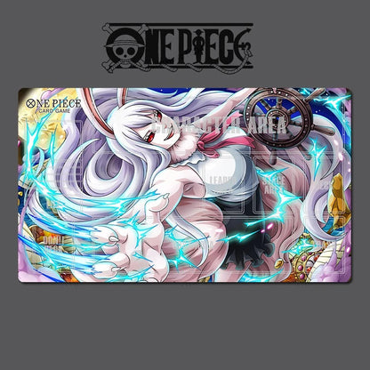 A One Piece trading card playmat featuring an anime illustration of a white-haired character with pink and blue energy effects, shown on a dark gray background with the One Piece logo at the top.