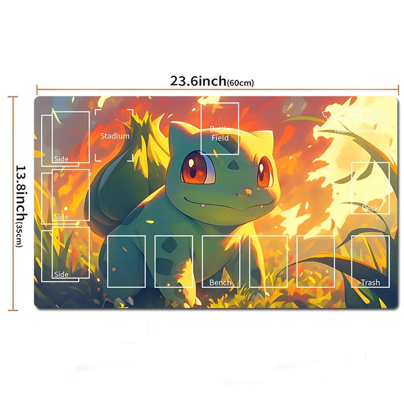 A Pokémon-themed gaming playmat featuring Bulbasaur, with printed dimensions showing 23.6 inches by 13.