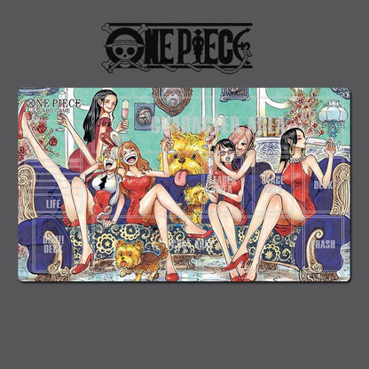 A One Piece themed rectangular desk mat or mousepad featuring an illustration of several female characters lounging on a sofa with drinks, set against a light teal background. The One Piece logo is printed at the top of the mat.