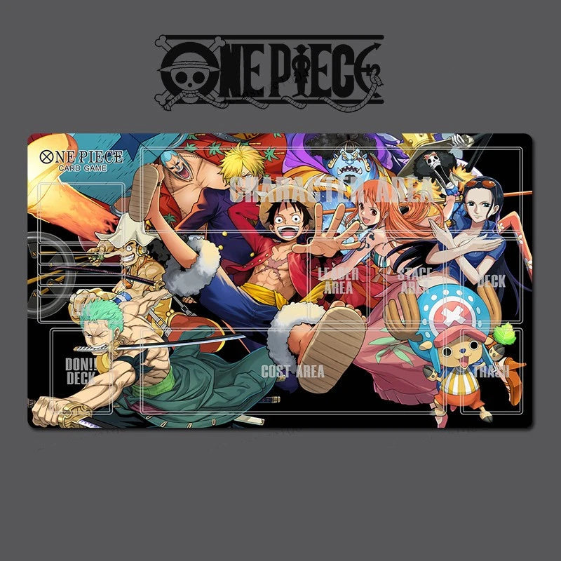 A rectangular One Piece themed desk mat or mousepad featuring a colorful group illustration of the main characters on a black background, shown on a dark gray backdrop with the One Piece logo above it.