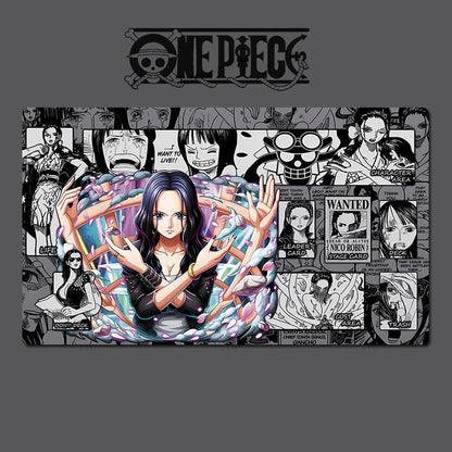 A One Piece themed rectangular desk mat or mousepad featuring a central anime illustration of Nico Robin surrounded by colorful energy effects, set against a black-and-white manga comic panel background. The One Piece logo is printed at the top, and the product is shown on a dark gray background with diagonal watermark text.