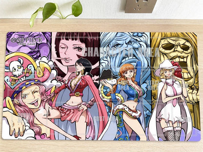 A rectangular anime desk mat featuring characters from One Piece: Pirate Square, laid flat on a light wood surface with a small green plant in the background. The mat has a colorful printed design with multiple character panels and a semi-transparent watermark reading 'CHARASAKU WAVE'.