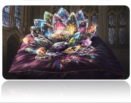 Colorful crystal flower on a dark fabric surface with a blurred background