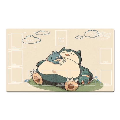 A rectangular desk mat featuring a cute illustration of Snorlax and its small blue dragon, with white text boxes for custom text placement on a light beige background.