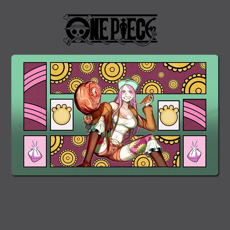 A rectangular One Piece themed desk mat or mousepad featuring an anime illustration of a character with pink hair and a green hat, set against a patterned background with yellow circles. The One Piece logo is printed at the top of the mat, which is displayed on a dark gray background with faint watermarks.