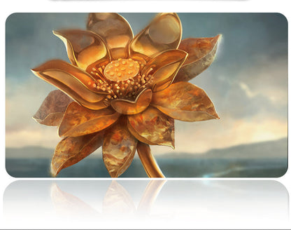 Decorative metal flower with a metallic sheen on a reflective surface