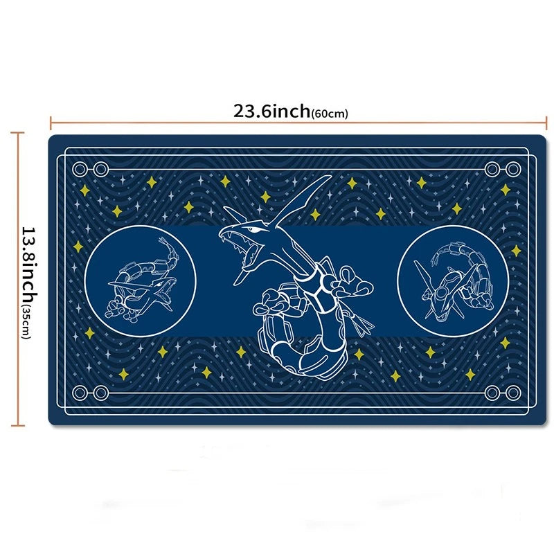 A rectangular dark blue mat or rug with Pokémon-themed line art, including a central Charizard and two circular figures on the sides, shown on a white background with dimension labels of 23.6 inches by 13.
