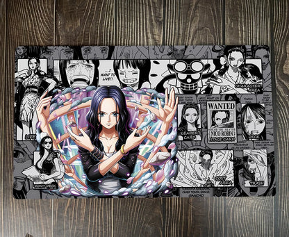 A rectangular printed mat or rug featuring One Piece anime artwork, including Nico Robin in the center, black-and-white character panels around her, and multiple One Piece WANTED posters, photographed on a dark wood floor.