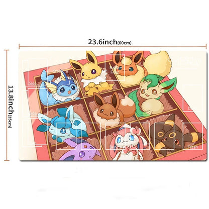 A rectangular printed mat or playmat featuring multiple Pokémon characters arranged in a grid, shown on a white background with dimension lines and measurements labeled 23.6 inches by 13.
