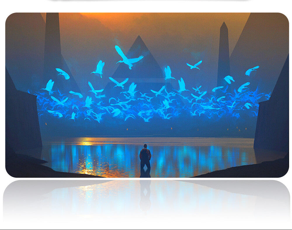 Projector with a screen displaying an animated scene of birds flying over water at sunset.