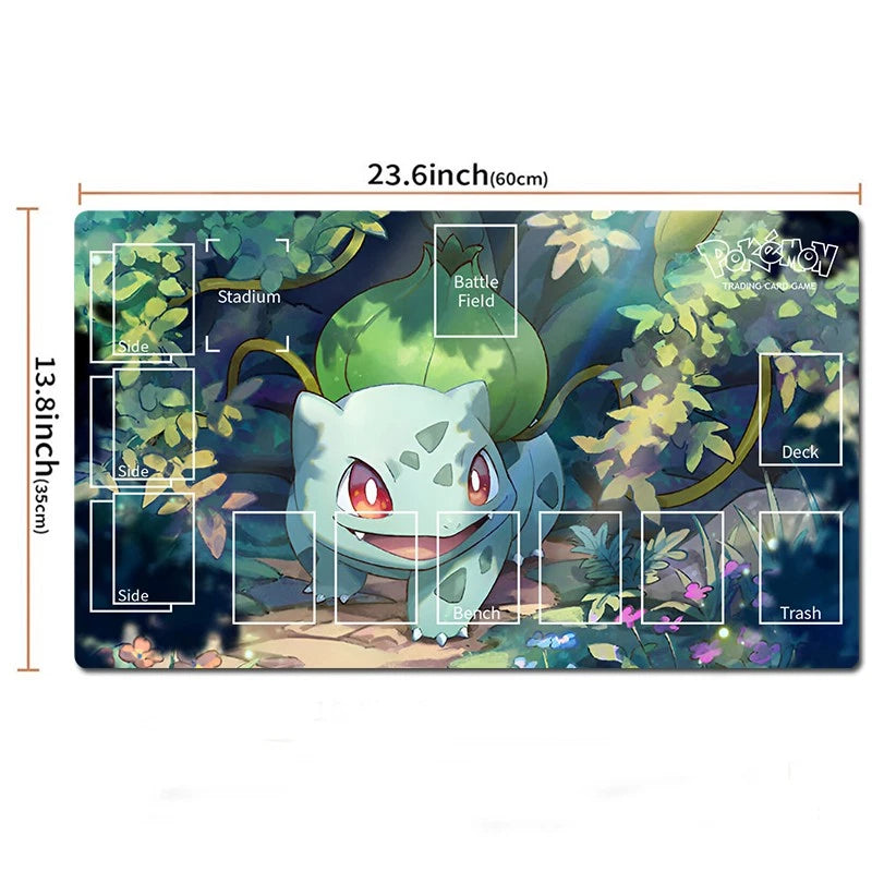 A Pokémon-themed playmat with Bulbasaur artwork, shown with printed layout guides and dimensions labeled 23.6 inches by 13.