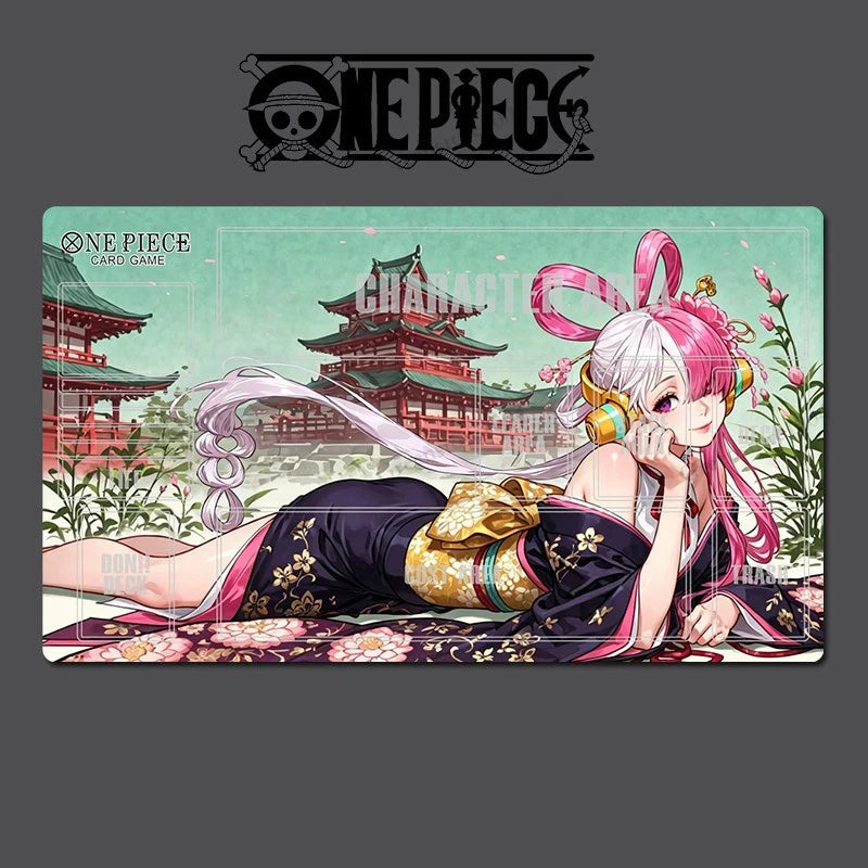 A One Piece: Pirate Gear Game character mat featuring an anime illustration of a pink-haired girl in a black and gold kimono reclining in front of a green castle, set against a dark gray background with the One Piece logo.
