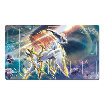 A rectangular Pokémon trading card playmat featuring a dynamic illustration of a white and gold Pokémon in a cosmic space scene with blue, purple, and orange light effects. The playmat includes printed white areas labeled for Slide, Battle, Deck, Trash, and Stadium, along with small illustrated card slots around the edges.