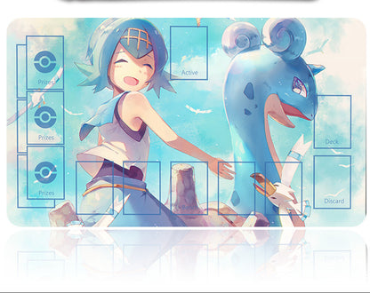 Card game mat with anime-style design featuring a character and a creature, with a pen on top.